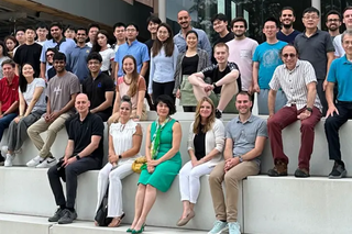 students from the statistics and data department sitting on white steps